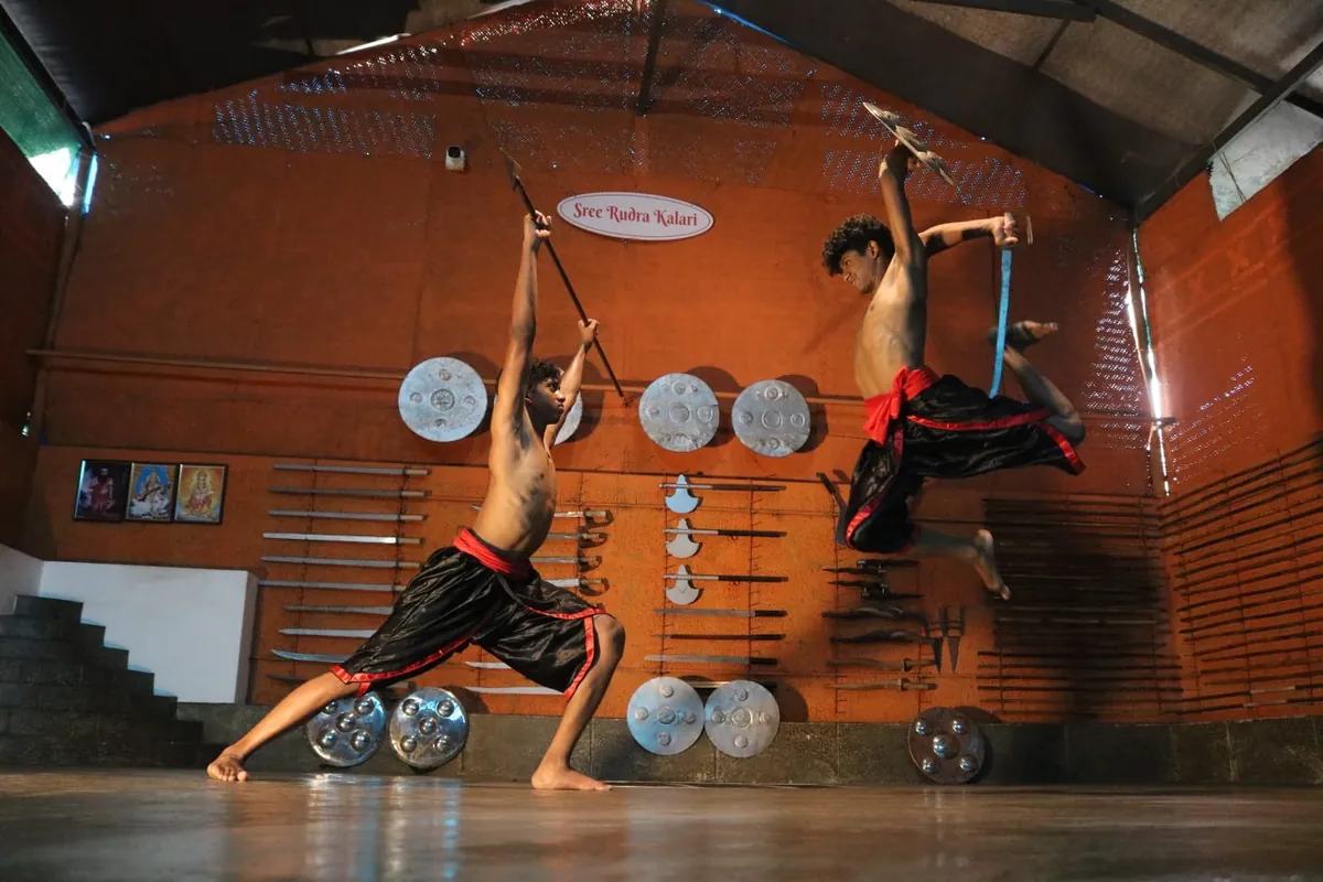 Students practising a leaping weapons sequence in the kalari at Sree Rudra Kalari, Tripunithura